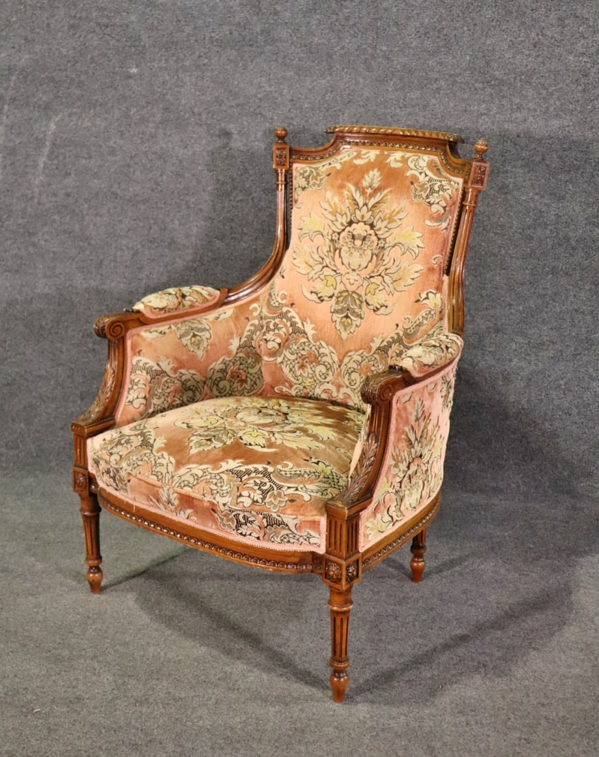 LOUIS XV STYLE BERGERE: Walnut frame. Upholstered. Carved. 38 1/4" h x 29 1/4" w x 25 1/2" d. Seat height 16 3/4".