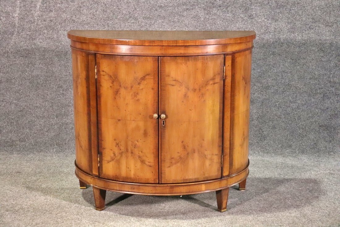 2 DOOR MAHOGANY BANDED DEMILUNE CABINET: 2 doors containing one wood shelf. Banded. 30" h x 33" w x 16" d.