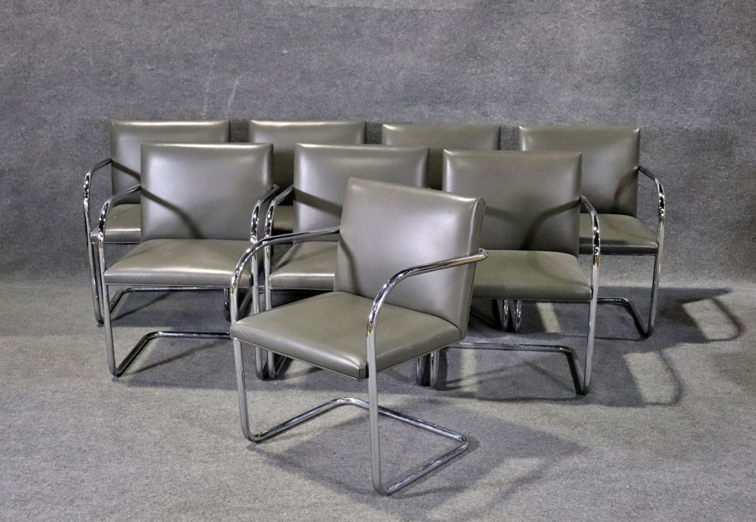 8 KNOLL CHROME & LEATHER ARM CHAIRS: Chrome frames. Leather upholstery. 31 1/2" h x 21 3/4" w x 24 1/2" d. Seat height 17 1/2".