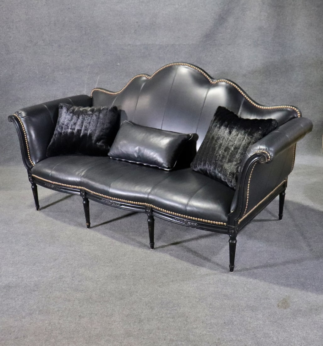 LOUIS XVI STYLE LEATHER "TAYLOR B" SOFA: Leather upholstery. Nail head trim. Ebonized legs. 46" h x 88" w x 40" d. Seat height 17".