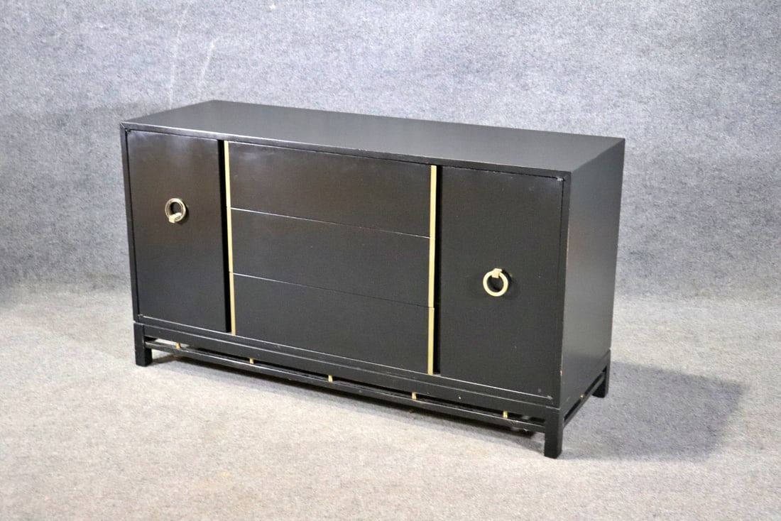 AMERICAN OF MARTINSVILLE EBONIZED SIDEBOARD: Ebonized. Brass hardware and accents. 2 doors containing 1 shelf each. 3 drawers. 31 1/4" h x 56" w x 20" d.