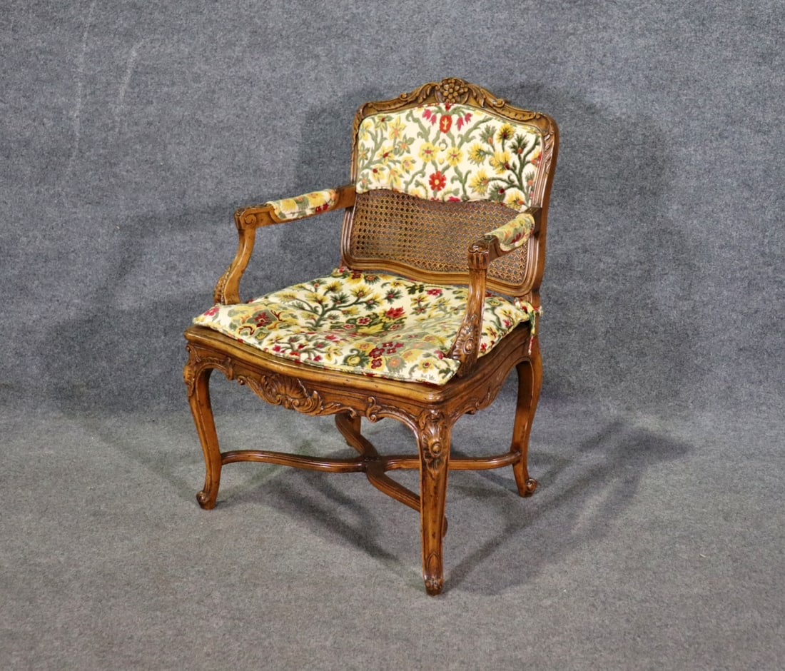 FRENCH LOUIS XV STYLE CANE WALNUT CARVED BOUDOIR CHAIR: Cane. Walnut. 35 1/4" h x 25 1/2" w x 24 1/4" d. Seat height 17 1/4".