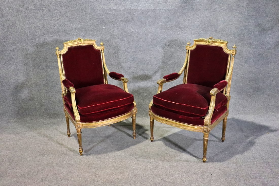 PAIR LOUIS XVI STYLE GILT FAUTEUILS: Carved gilt frames. Upholstered seat, back and arm rests. Nail head trim. 39 5/8" h x 25" w x 26 3/4" d. Seat height 21".