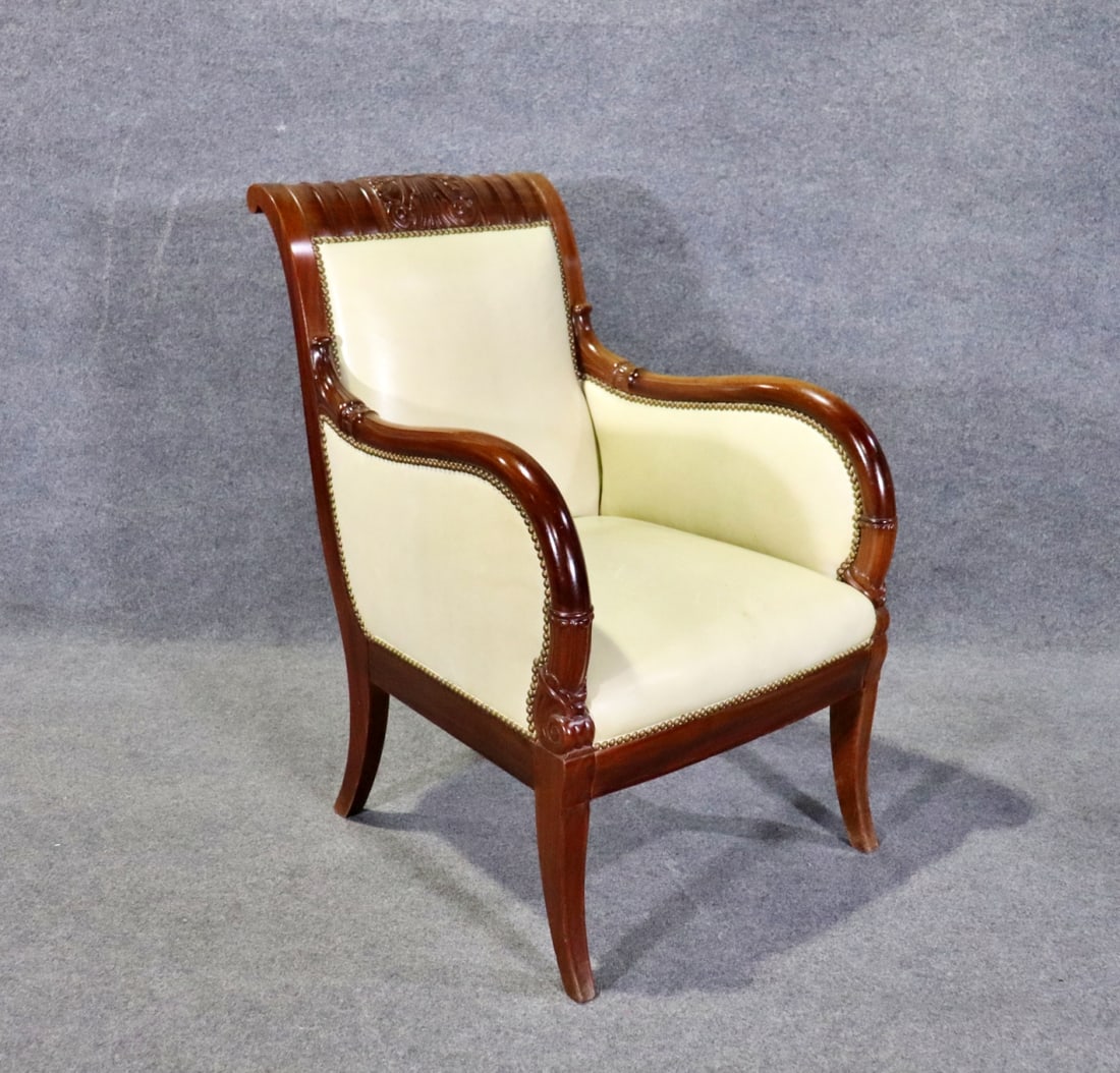 EMPIRE STYLE LEATHER BERGERE: Carved wood frame. Leather upholstery. Nail head trim. 39 3/8" h x 25 1/8" w x 34" d. Seat height 19 1/4".