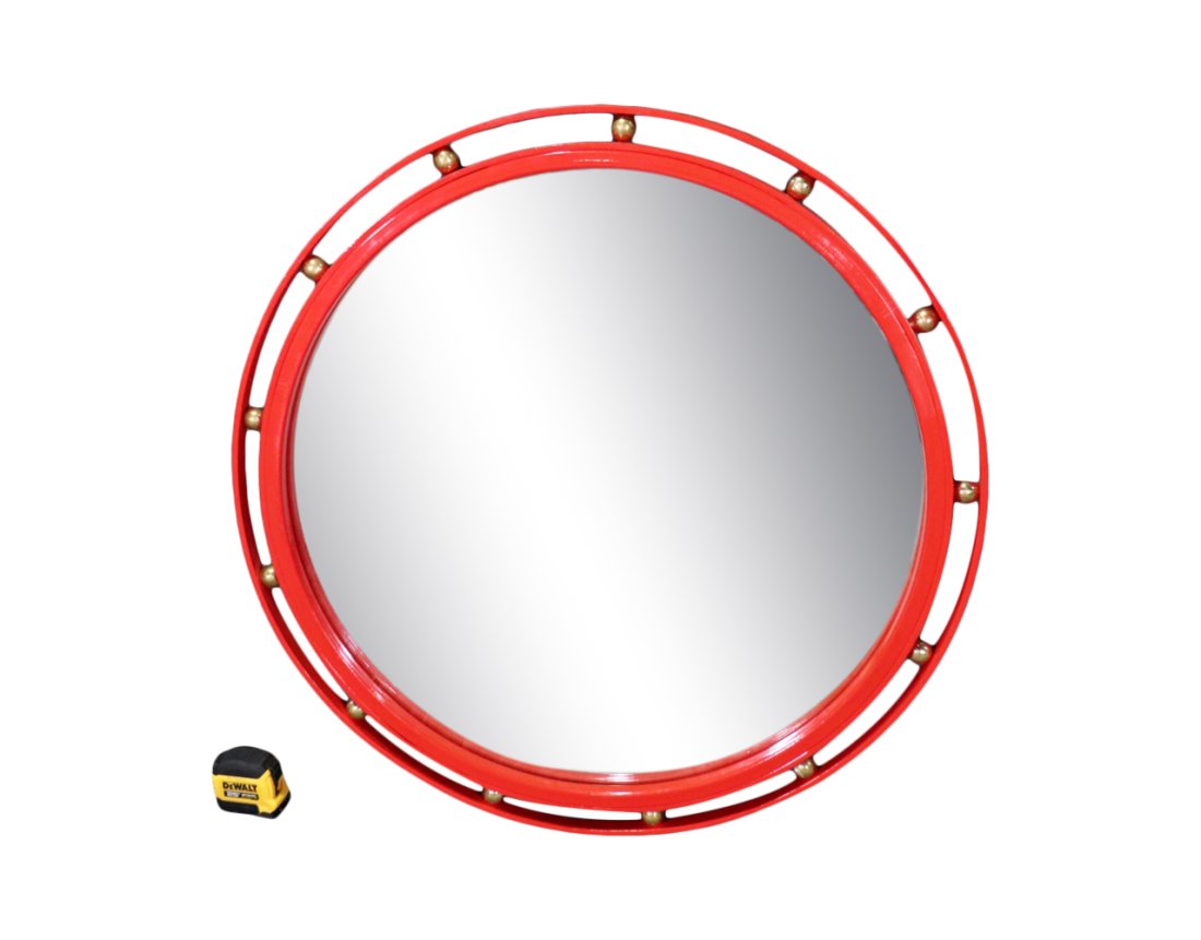 MID CENTURY STYLE METAL HANGING MIRROR: Round. Red painted metal. Brass accents. 33 3/8" h x 33" diameter.