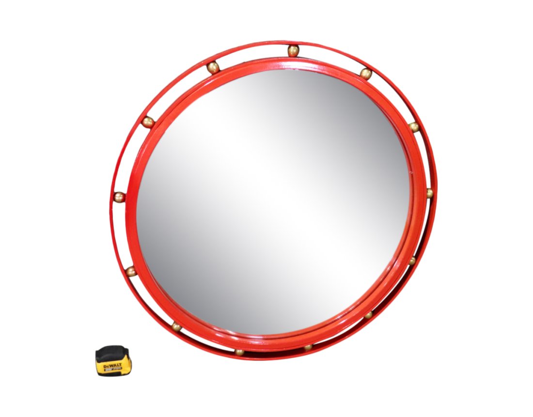 MID CENTURY STYLE METAL HANGING MIRROR: Round. Red painted metal. Brass accents. 33 3/8" h x 33" diameter.