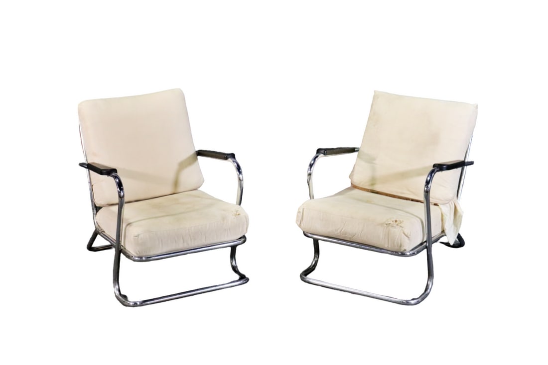 PAIR SIGNED KEM WEBER ART DECO TUBULAR CHROME LOUNGERS: E 27 and 2803. Chrome frames. Upholstered cushions, back and seat. 31 1/2" h x 25 5/8" w x 34" d. Seat height 15".