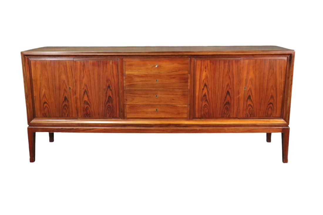 ROSEWOOD SIDEBOARD: Rosewood. 4 dovetailed drawers in center. 2 doors on each side. 33 1/4" h x 76 3/4" w x 19 1/2" d.