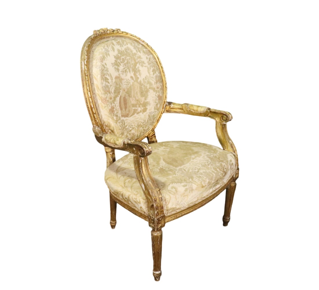 LOUIS XVI STYLE GILDED FAUTEUIL: Gilded. Carved wood. Tapestry upholstery. 39" h x 24 3/4" w x 27 3/4" d. Seat height 18".