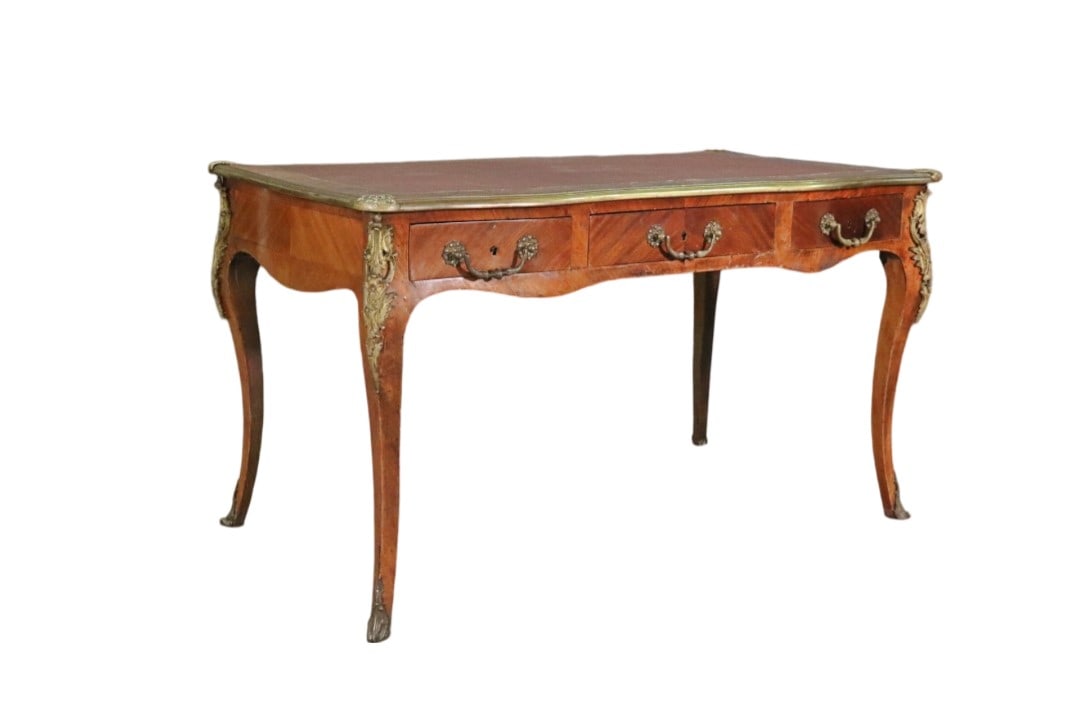 LOUIS XV STYLE LEATHER TOP BUREAU PLAT: Wood. Leather top. 3 dovetailed drawers. Bronze ormolu. One faux drawer on other side. 29 5/8" h x 51 1/2" w x 28 1/4" d.