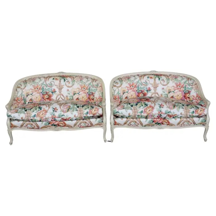 PAIR LOUIS XV STYLE PAINT DECORATED SETTEES: 1950's-60's era. Floral upholstered. Paint decorated frames. 33 1/2" h x 51" w x 30 1/2" d. Seat height 18 1/2".