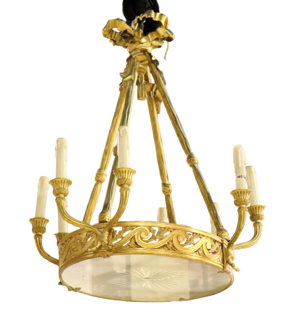 BRASS RIBBON FORM 8 LIGHT CHANDELIER: Brass frame. Etched frosted glass bottom 8 lights. 30" h x 29 3/4" w x 25 1/2" d.