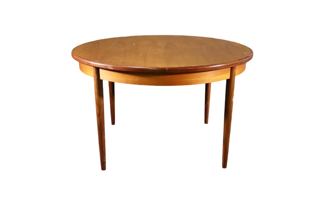 MODERN TEAK DINING TABLE: Teak. 28 1/4" h x 48 1/2" diameter (closed). 1 - 18" leaf under table.