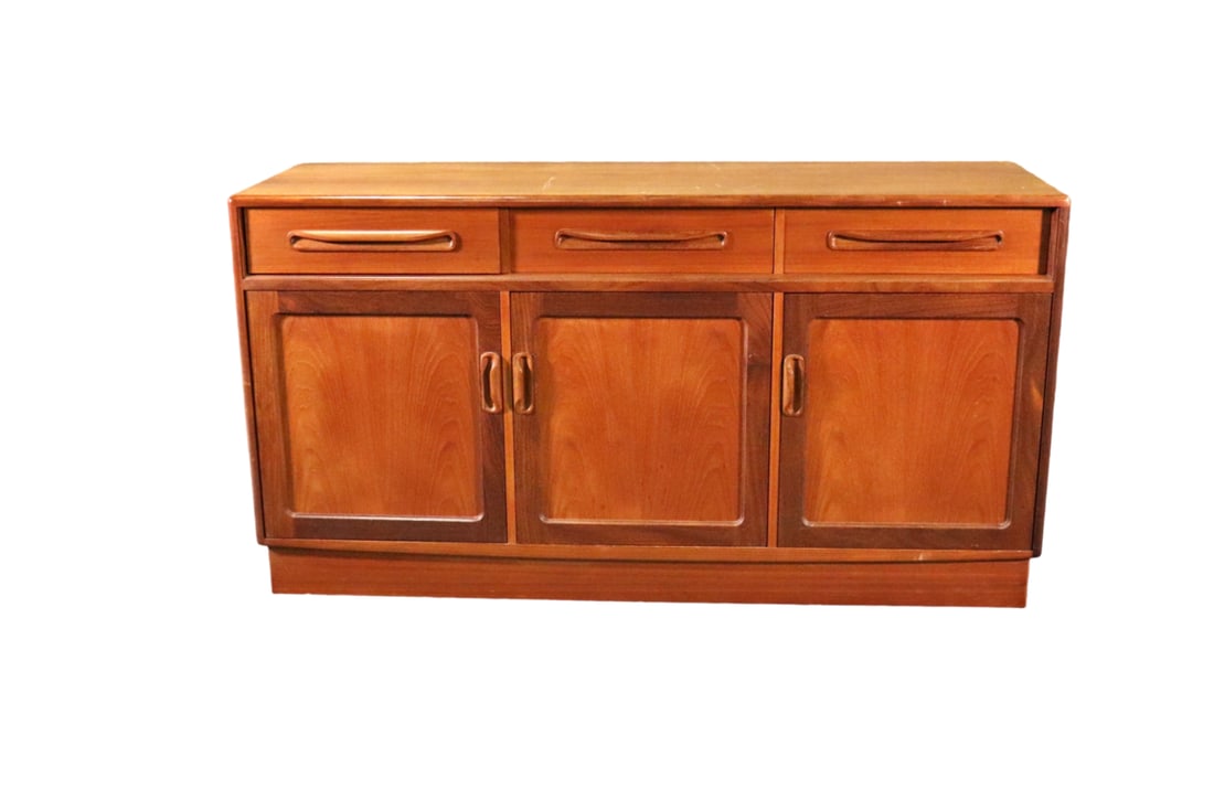 MODERN TEAK SIDEBOARD: Teak. 3 dovetailed drawers. 3 doors each containing 1 shelf. 30" h x 55 1/2" w x 17 1/2" d.