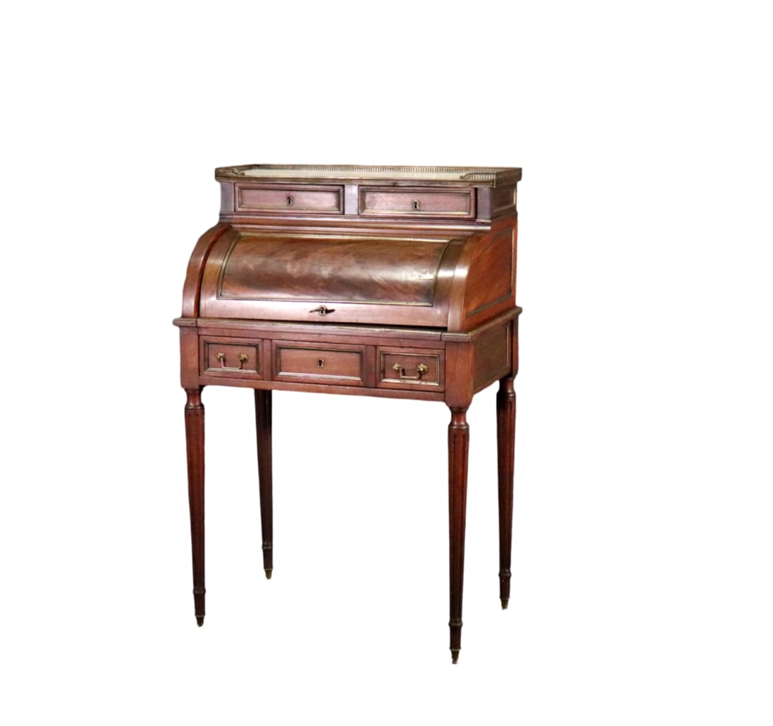 DIRECTOIRE CYLINDER DESK: Marble top with gallery. Wood. 2 drawers on top. Roll top with leather top and fitted interior. One drawer. Brass accents. 40 1/4" h x 26 1/4" w x 16 1/2" d.