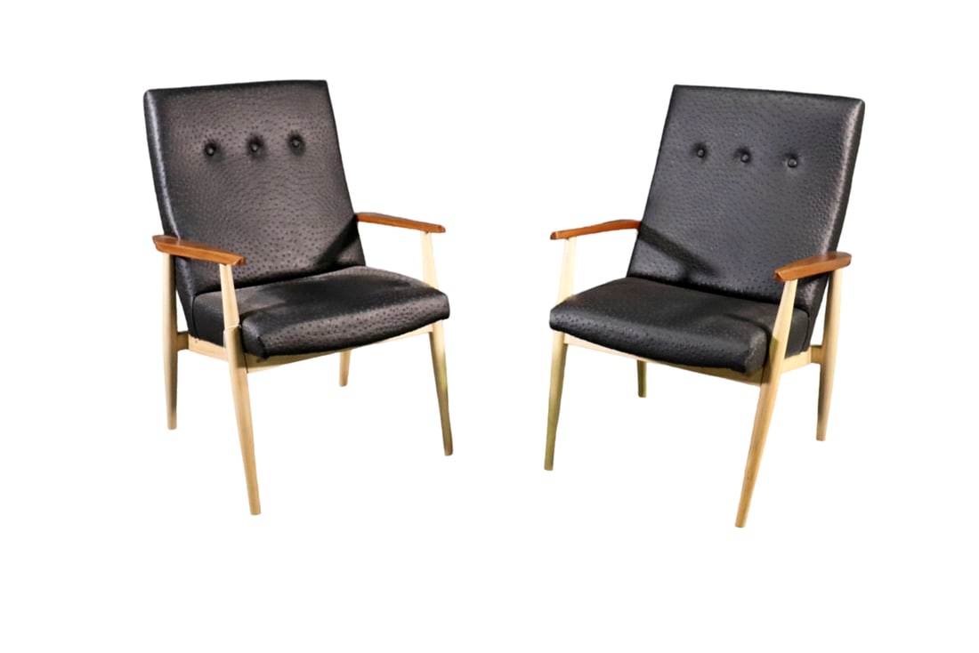 PAIR MID CENTURY MODERN LOUNGE CHAIRS: Walnut frames. Vinyl upholstery. Nail head trim. 35" h x 24 3/4" w x 24 1/2" d. Seat height 17 3/4".