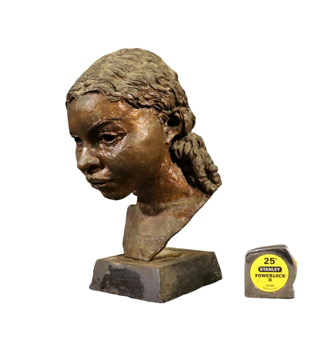 BRONZE BUST WOMAN'S FACE: Bronze. Slate base. 15 1/2" h x 7 1/2" w x 9" d.