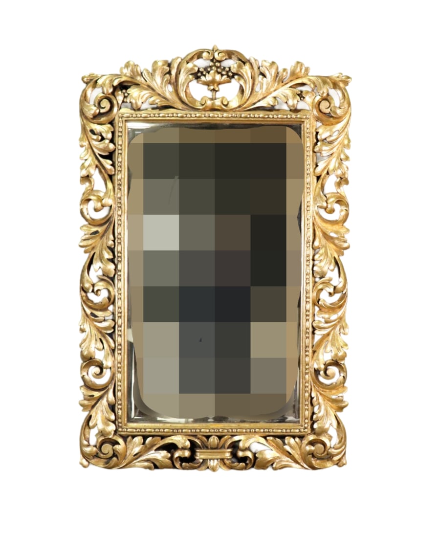 CARVED GILT WOOD MIRROR: Carved gilt wood frame. Beveled glass. 56" h x 35" w x 1 1/2" d.