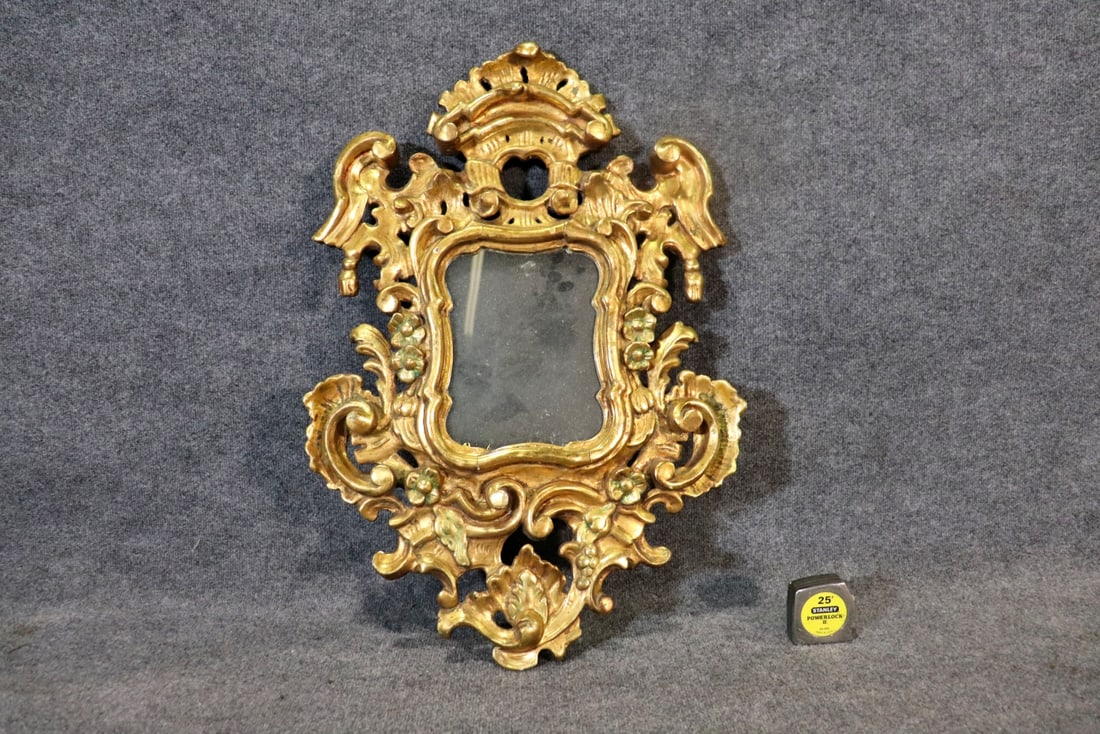 ITALIAN CARVED GILT WOOD HANGING MIRROR: Wood. Carved. Gilt. 31 5/8" h x 22" w x 2" d.