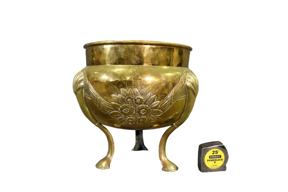 CARVED BRASS COATED PLANTER: Carved. Brass coated metal. 14" h x 15" diameter.