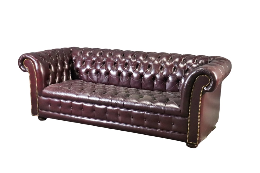 CHESTERFIELD LEATHER SOFA: Leather upholstery. Nail head trim. Wood legs. Tufted. 27 3/4" h x 73 3/4" w x 33 1/2" d. Seat height 14".