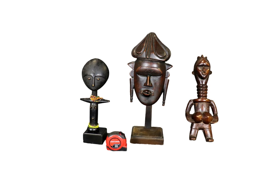 3 CARVED AFRICAN SCULPTURES: Carved wood. One measures 17 1/4" h x 6 1/2" w x 4" d. One measures 19 1/2" h x 8" w x 7 1/2" d. One measures 14 1/2" h x 5 1/2" w x 3 1/2" d.