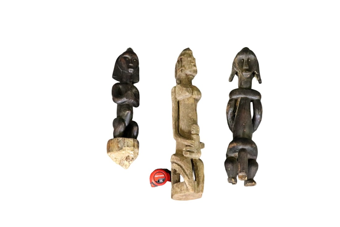 3 CARVED AFRICAN SCULPTURES: Carved wood. One measures 21 1/4" h x 5 1/4" w x 5 1/4" d. One measures 26" h x 5" w x 6" d. One measures 22 3/4" h x 6" w x 6 3/4" d.