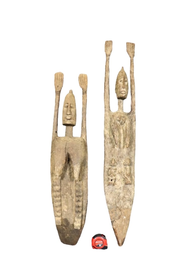 2 CARVED AFRICAN SCULPTURES: Carved wood. One measures 45 3/4" h x 7" w x 6" d. One measures 38" h x 8 1/2" w x 6" d.
