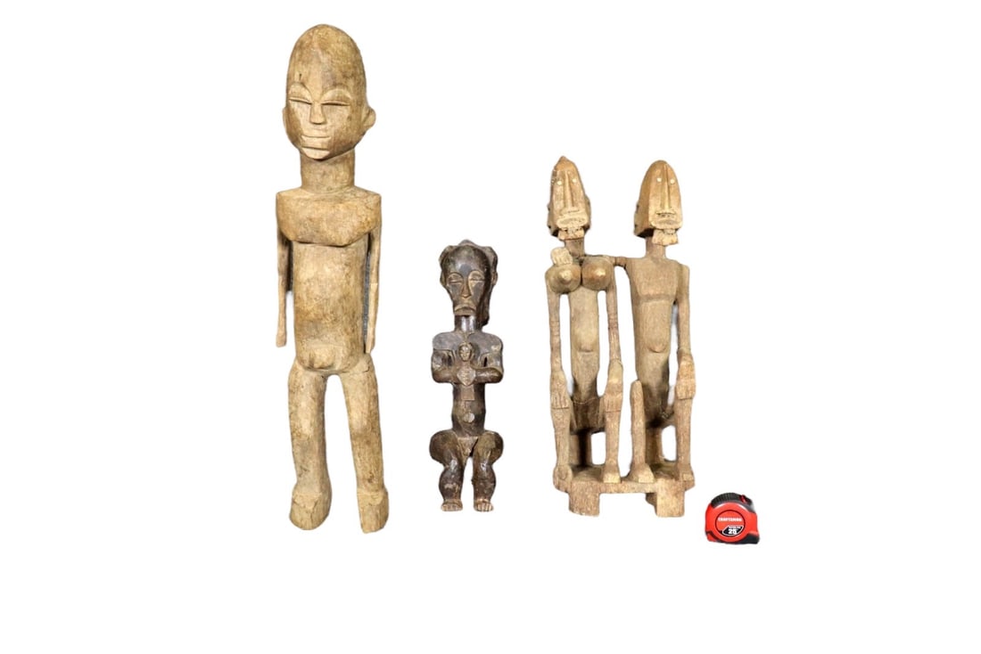 3 CARVED AFRICAN SCULPTURES: Carved wood. One measures 19" h x 5 3/8" w x 5 1/4" d. One measures 23 1/2" h x 10 1/2" w x 6 3/4" d. One measures 31 3/4" h x 6 1/2" w x 6 1/2" d.