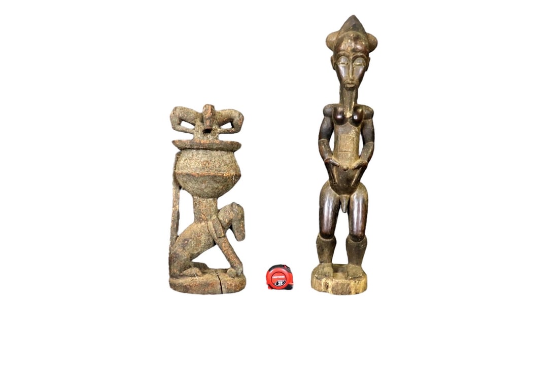 2 CARVED AFRICAN SCULPTURES: Carved wood. One measures 34" h x 7" w x 7" d. One measures 22" h x 8" w x 9" d.
