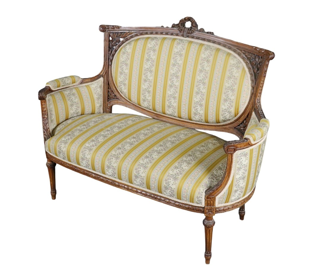 FRENCH LOUIS XVI STYLE WALNUT LOVESEAT: Carved wood frame. Upholstered. 42 3/4" h x 54" w x 28" d x 19 1/2" seat height.