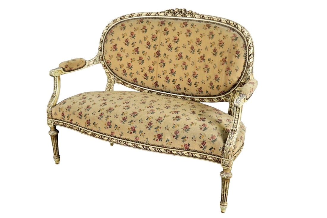LOUIS XVI STYLE HEAVILY CARVED SETTEE: Distress painted. Nail head trim. Upholstered. 39 3/4" h x 49 3/4" w x 29 1/2" d. Seat height 19 1/4".