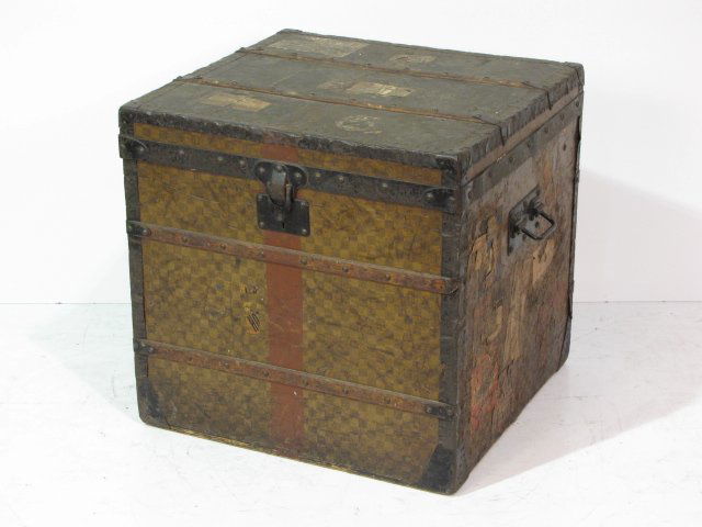 ANTIQUE LOUIS VUITTON TRUNK: Fair condition with lots of wear. 25"h. x 26"w. x 25"d.