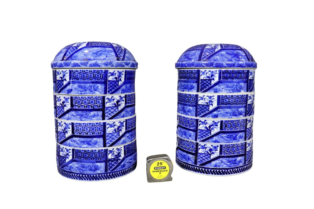 PAIR JAPANESE STACKABLE PORCELAIN BOXES: Porcelain. Painted. 5 pieces. Blue and white. 18" h x 10 1/2" diameter.