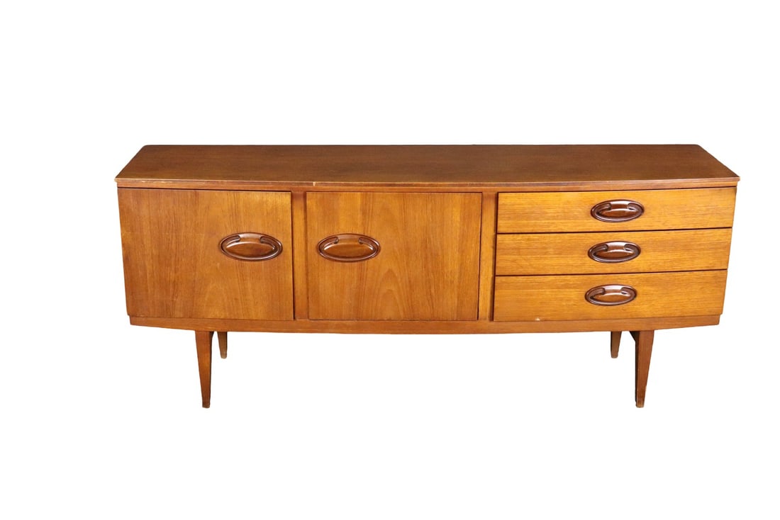 MID CENTURY MODERN TEAK SIDEBOARD: Teak. 3 drawers. One door on left containing one shelf. One drop down door in middle containing one shelf. 30 1/4" h x 72 1/4" w x 18 3/4" d.