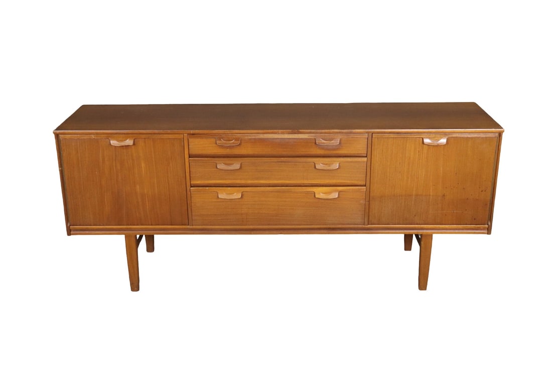 MID CENTURY MODERN TEAK SIDEBOARD: Teak. 3 dovetailed drawers. 2 doors. One shelf in right door. 30" h x 72 1/4" w x 18" d.