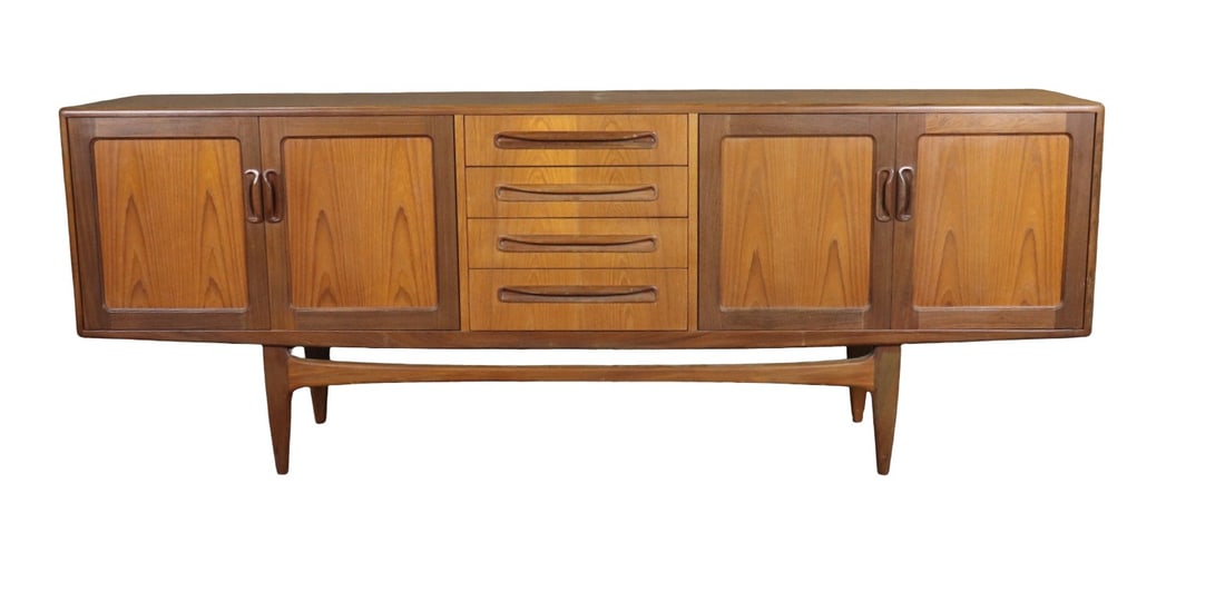 MID CENTURY MODERN TEAK SIDEBOARD: Teak. 4 dovetailed drawers. 4 doors contained one shelf on each side. 31 1/4" h x 84" w x 18" d.