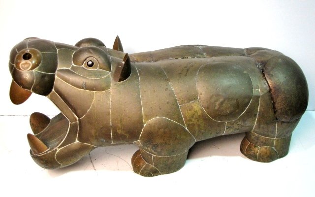35" SERGIO BUSTAMANTE COPPER PATCHWORK HIPPO: Good condition. Some loose seams. Dent on nose. 15"h. x 13 1/2"w. x 35" long. From a large collection of hippos, many additional hippos will be offered in our in-house uncatalogued auction.