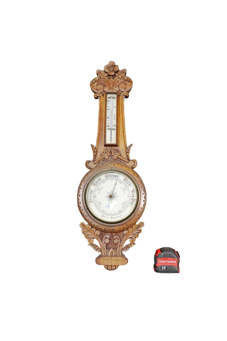 ENGLISH BAROMETER: Heavily carved wood. White face thermometer at bottom. 28 1/2" h x 9" w x 2 1/2" d.