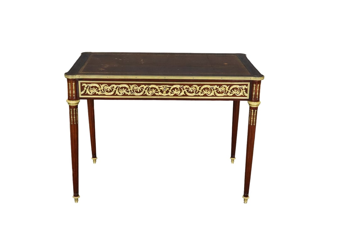 LOUIS XVI STYLE LEATHER TOP SALON TABLE AFTER MODEL OF LINKE: Leather top. Bronze mounts. One dovetailed drawer. 29 1/8" h x 39 3/4" w x 24" d.
