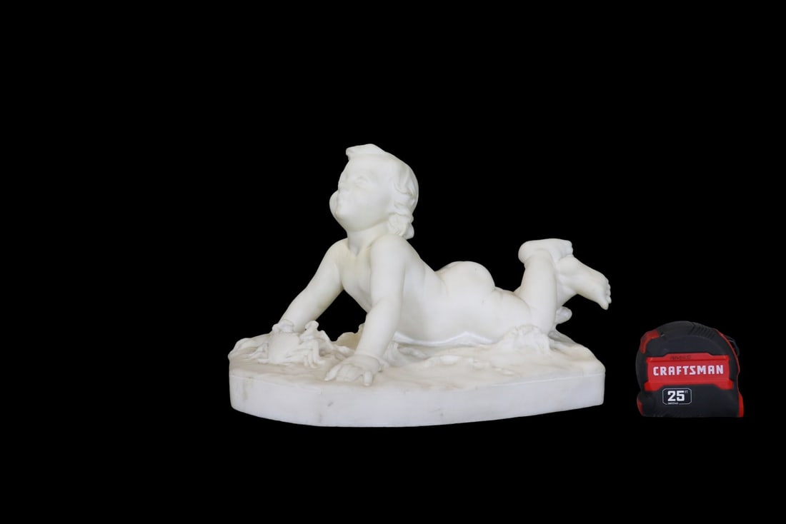 SIGNED POGI MARBLE BABY SCULPTURE: Marble. Signed Pogi on base. 9 1/4" h x 14 1/4" w x 7 1/2" d.