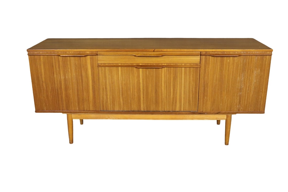 MID CENTURY MODERN TEAK SIDEBOARD: Teak. 1 dovetailed drawer. 2 doors containing 1 shelf. 1 drop down door containing 1 shelf. 29 1/2" h x 66" w x 18 3/4" d.