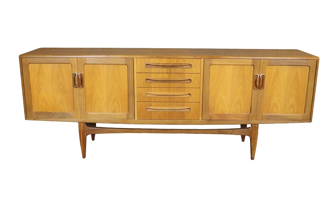 MID CENTURY MODERN TEAK SIDEBOARD: Teak. Center has 4 dovetailed drawers. 2 doors on each side containing 1 shelf each. 31" h x 84" w x 18 1/4" d.