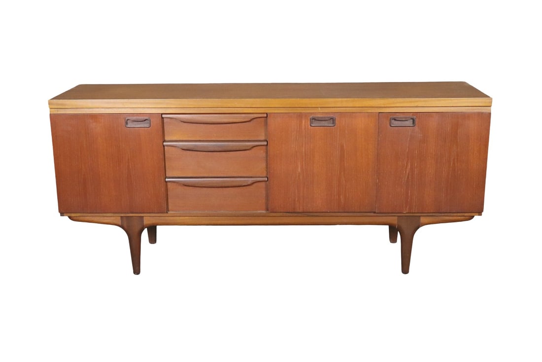 MID CENTURY MODERN TEAK SIDEBOARD: Teak. 3 dovetailed drawers. 1 drop down door and 1 door on right containing 1 shelf. 1 door on left side containing 1 shelf. 30 3/8" h x 69 1/4" w x 17 5/8" d.