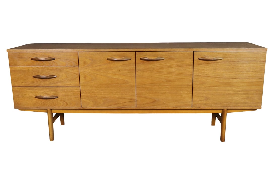 MID CENTURY MODERN TEAK SIDEBOARD: Teak. 3 drawers on left side. 3 doors containing 1 shelf each. 28 1/2" h x 72" w x 18" d.