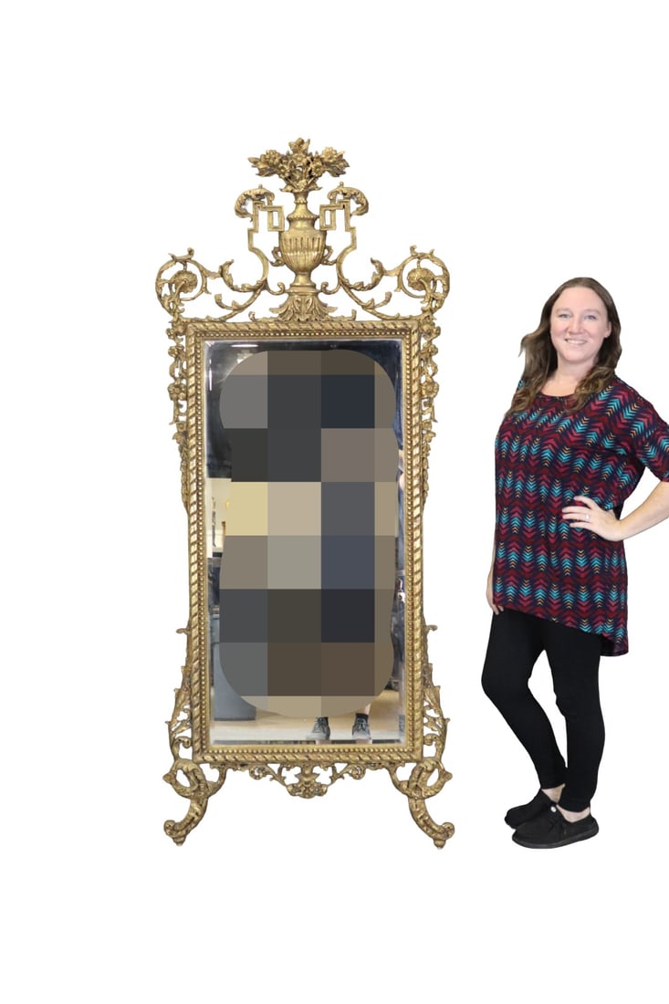 HEAVILY CARVED MIRROR: Heavily carved. Double glass. Beveled. Gilt. 79 1/4" h x 35" w x 3 3/4" d.