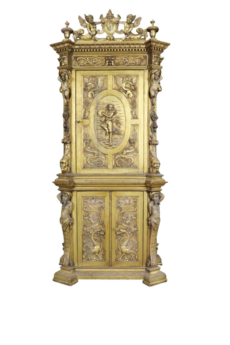 CARVED GILTWOOD CABINET: 7 pieces. Carved. Figural. Gilt painted. 2 doors on bottom containing 1 shelf. 2 doors on top containing 2 shelves. 87" h x 37 1/2" w x 24" d.