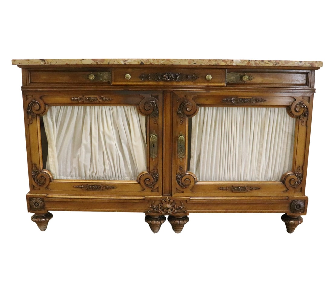 MARBLE TOP BUFFET: Marble top. Carved. 3 drawers. Metal hardware. 2 glass doors on bottom containing 3 shelves. 41 1/2" h x 66" w x 23 3/4" d.