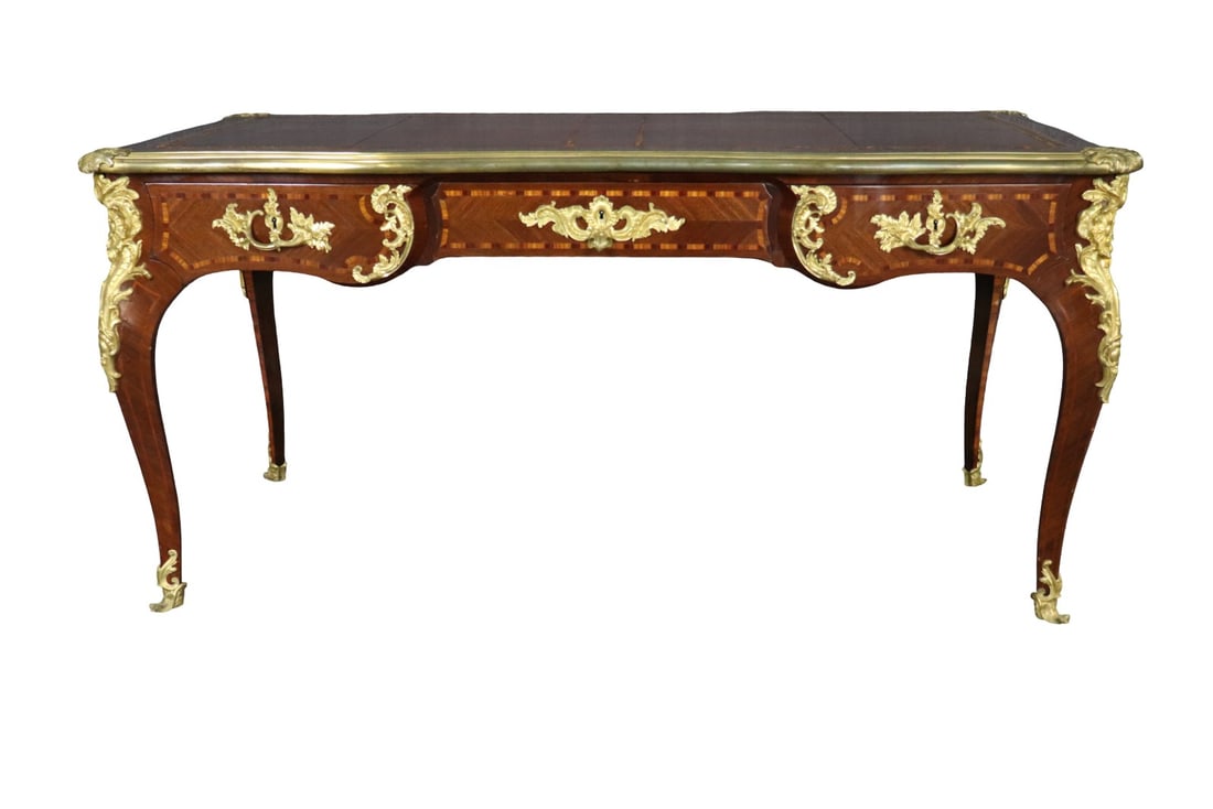 LOUIS XV STYLE BRONZE MOUNTED LEATHER TOP DESK ATTRIBUTED F LINKE: Bronze mounted. 3 drawers. Leather top. 31 1/8" h x 64 1/2" w x 31 1/2" d.