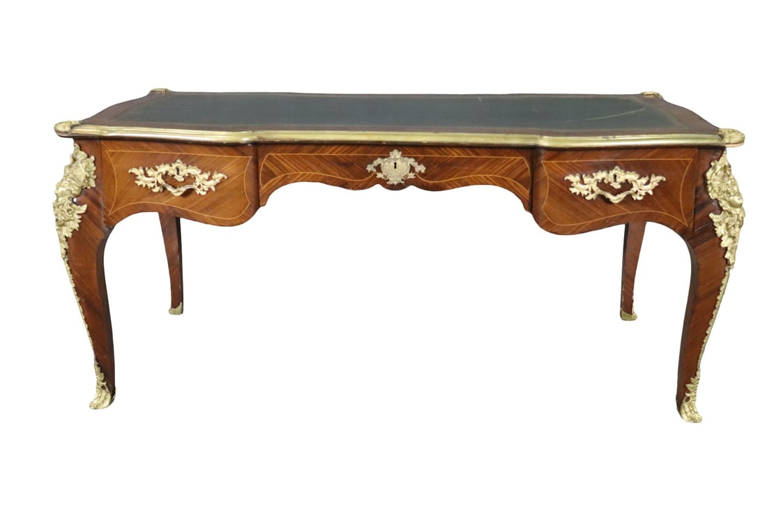 LOUIS XV STYLE LEATHER TOP BRONZE MOUNTED DESK AFTER PAUL SORMANI: Figural. Bronze mounted. 3 dovetailed drawers. Leather top. 30 5/8" h x 68 1/4" w x 35 3/4" d